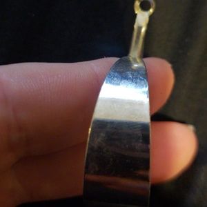 Very lightweight silver colored hood earrings.
